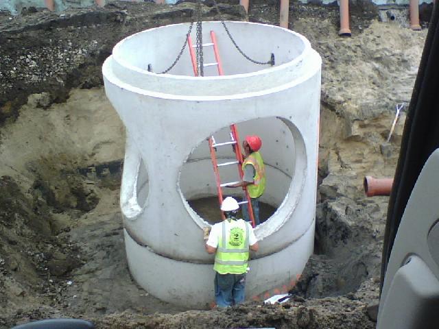 A man standing next to a hole in the ground.
